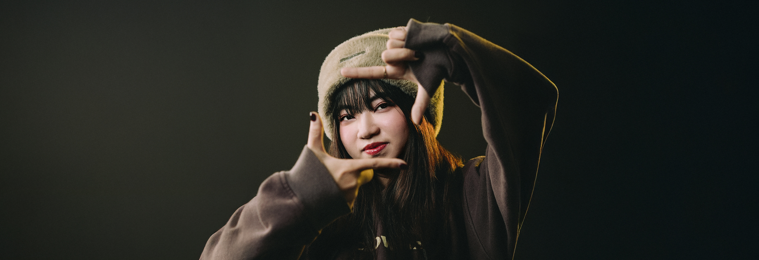 Portrait of Huong in a dark-toned setting